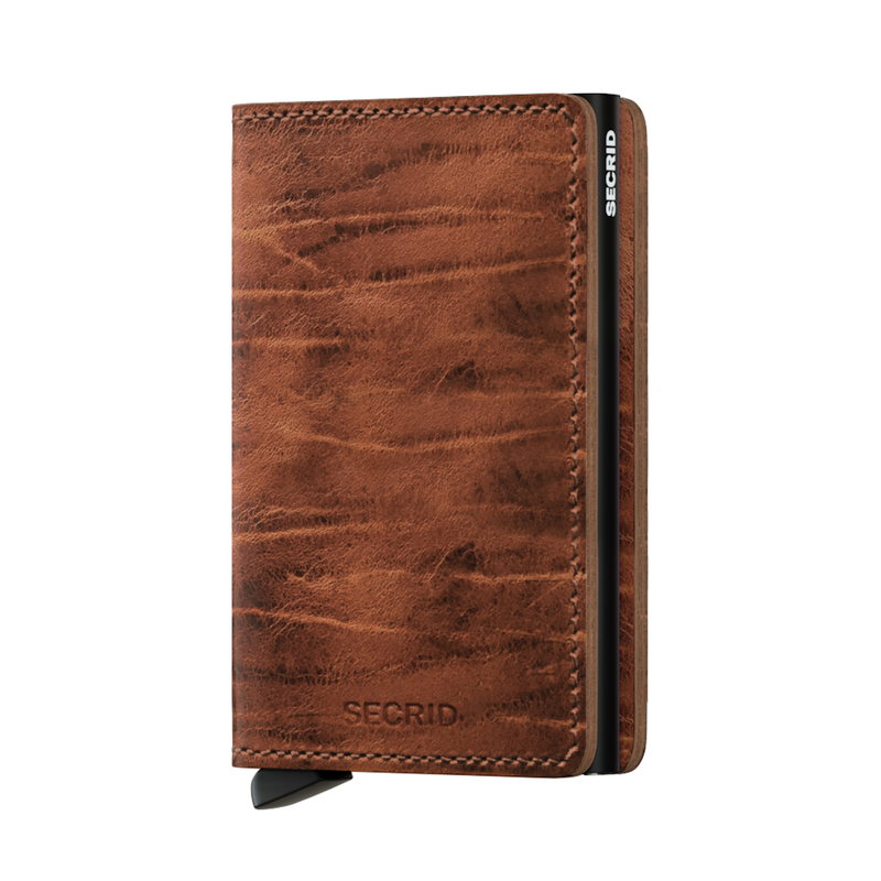 Meet the the Secrid Slimwallet Dutch, an RFID protective wallet built in an aluminium case to protect your credit cards from bending, scratching or any data theft. Named after a Dutch artisan who specialises in leather finishing, this leather is exclusively crafted for these wallets. A hard carnauba wax gives the Dutch Martin a characteristic look and feel. The Slimwallet Dutch Martin is full-grain leather, made in Holland from European cowhide. 